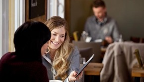 Woman Showing Digital Tablet to Friend