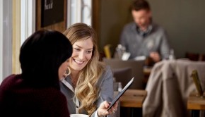 Woman Showing Digital Tablet to Friend