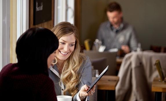 Woman Showing Digital Tablet to Friend